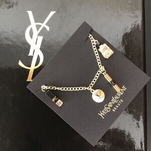 YSL Gold tone charm bracelet with four YSL charms